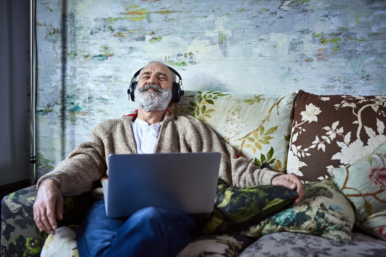 Man relaxing with headphones and computer