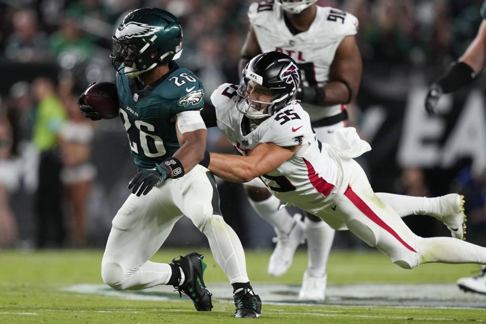 Philadelphia Eagles running back Saquon Barkley, left, is tackled by Atlanta Falcons linebacker Kaden Elliss (55) after a catch during the second half of an NFL football game Monday, Sept. 16, 2024, in Philadelphia. (AP Photo/Matt Slocum)