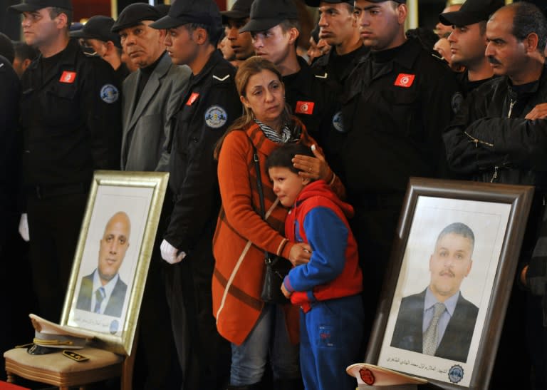 Family members of the presidential guards who were killed in the bus bomb blast in Tunis, during an official ceremony to honour them on November 25, 2015