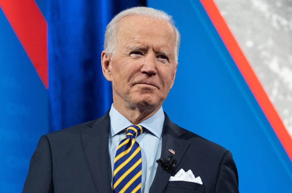 US President Joe Biden holds a face mask as he participates in a CNN town hall at the Pabst Theater in Milwaukee, Wisconsin, February 16, 2021. (Photo by SAUL LOEB / AFP) (Photo by SAUL LOEB/AFP via Getty Images)