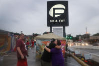 <p>Neema Bahrami and Jacque Azevrdo (L-R) hug outside the Pulse gay nightclub one day before the one year anniversary of the shooting on June 11, 2017 in Orlando, Florida. (Joe Raedle/Getty Images) </p>