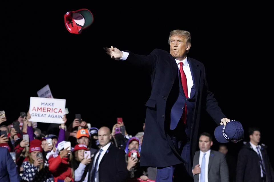 President Donald Trump throws hats into the crowd after speaking at a campaign rally at Duluth International Airport, Wednesday, Sept. 30, 2020, in Duluth, Minn. (AP Photo/Alex Brandon)