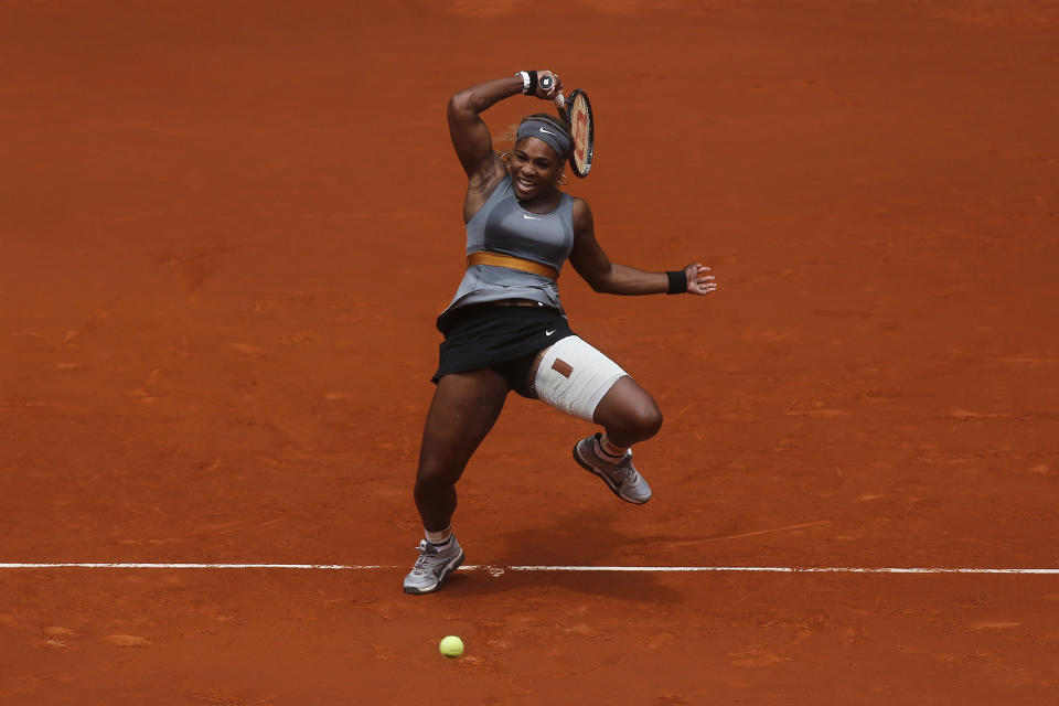 FILE - Serena Williams from US returns the ball to Shuai Peng from China during a Madrid Open tennis tournament match in Madrid, Spain, Wednesday, May 7, 2014. After nearly three decades in the public eye, few can match Serena Williams' array of accomplishments, medals and awards. Through it all, the 23-time Grand Slam title winner hasn't let the public forget that she's a Black American woman who embraces her responsibility as a beacon for her people. (AP Photo/Andres Kudacki, File)