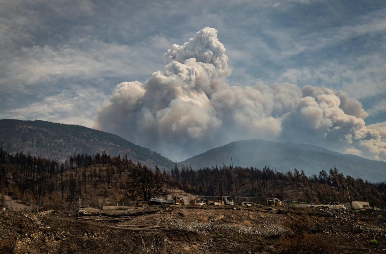 <span class="caption">Properties destroyed by the Lytton Creek wildfire on June 30 are seen as a cloud produced by the fire rises in the mountains above Lytton, B.C. </span> <span class="attribution"><span class="source">THE CANADIAN PRESS/Darryl Dyck </span></span>