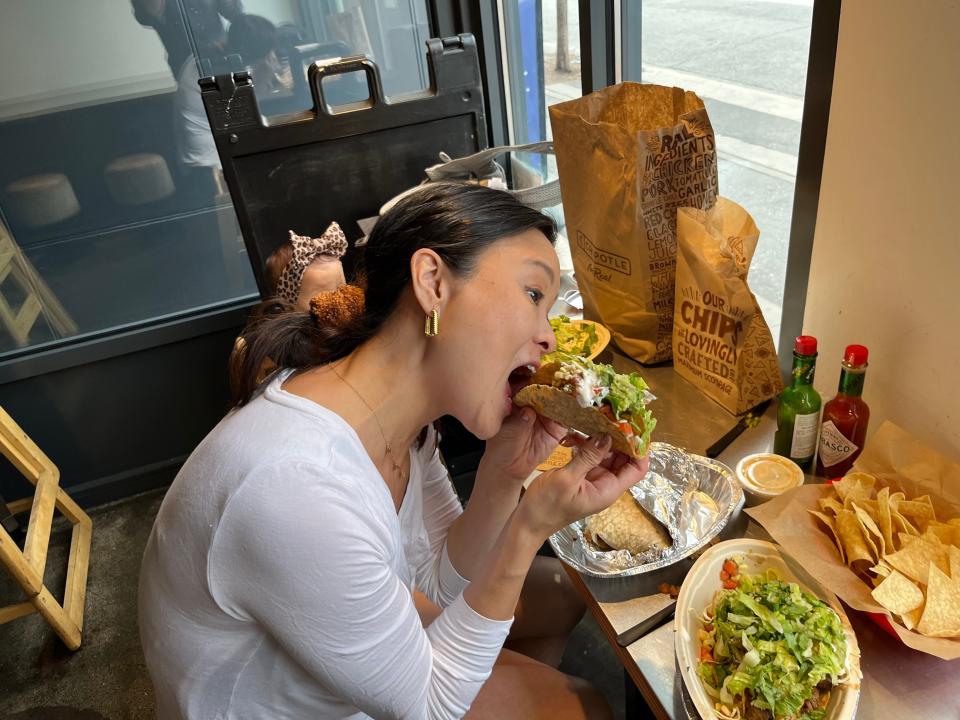 tiffany eating a taco at chipotle