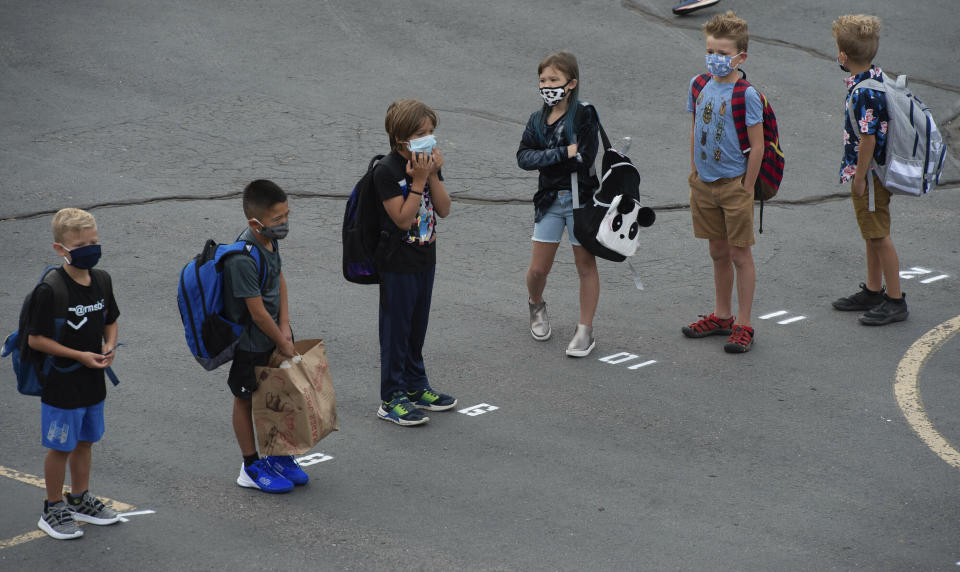 Students at Canyon View Elementary in Cottonwood Heights line up on the playground as they go back to school for the first day of classes for the Canyons School District on Monday, August 24, 2020. (Francisco Kjolseth/The Salt Lake Tribune via AP)