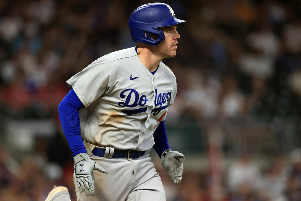 Los Angeles Dodgers' Freddie Freeman runs to first after a hit during the ninth inning of a baseball game against the Atlanta Braves, Friday, June 24, 2022, in Atlanta. (AP Photo/Butch Dill)