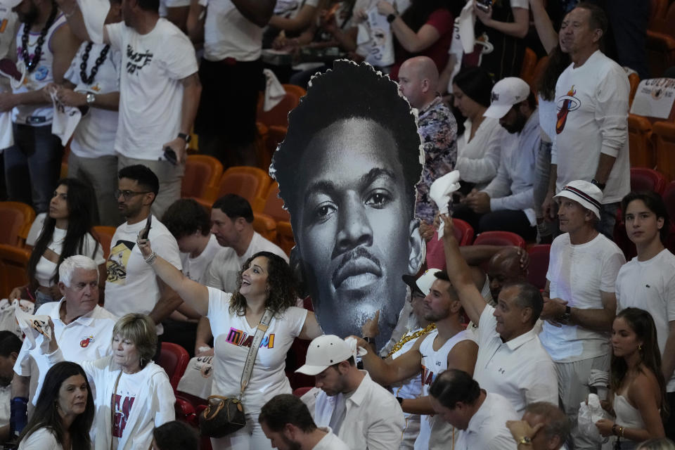Miami Heat fans take selfies with a large cutout of Miami Heat forward Jimmy Butler during the first half of Game 3 of the NBA Finals basketball game against the Denver Nuggets, Wednesday, June 7, 2023, in Miami. (AP Photo/Rebecca Blackwell)