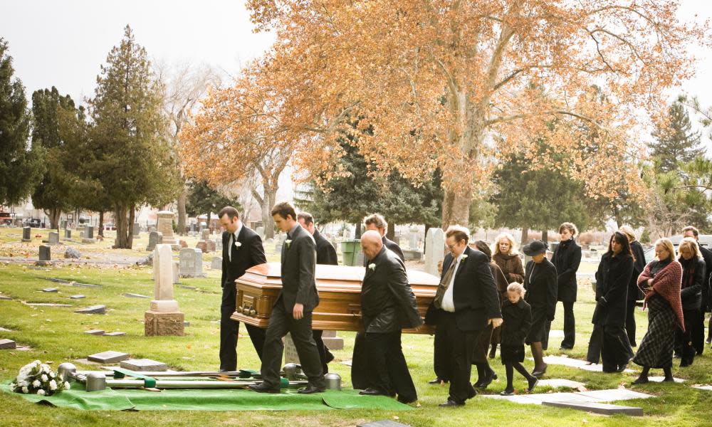 People at a funeral in a cemetery