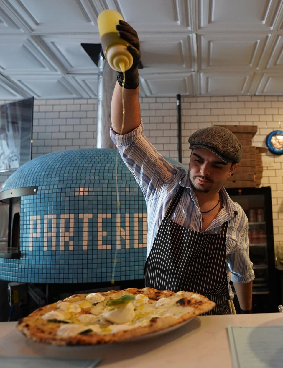 Chef Daniel Nizzardini of Pizzetiello, which is set to open in Pearl River, adds olive oil to a DAM (Diego Armando Maradona) pizza. Tuesday, August 29, 2023.