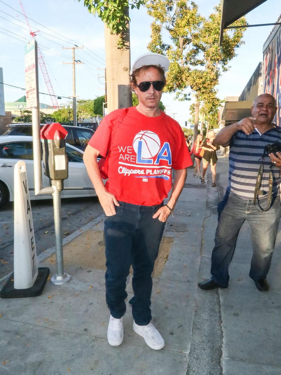 A man poses on the street