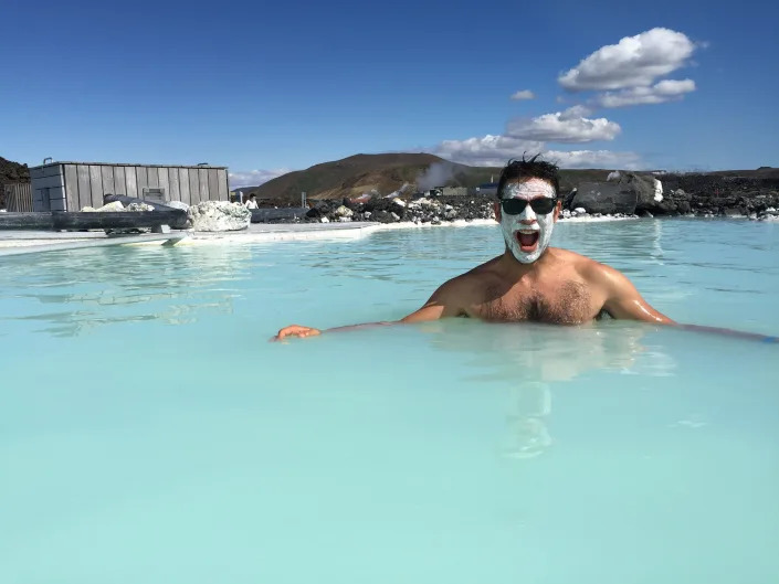 A man in the blue lagoon in Iceland with a face treatment on.