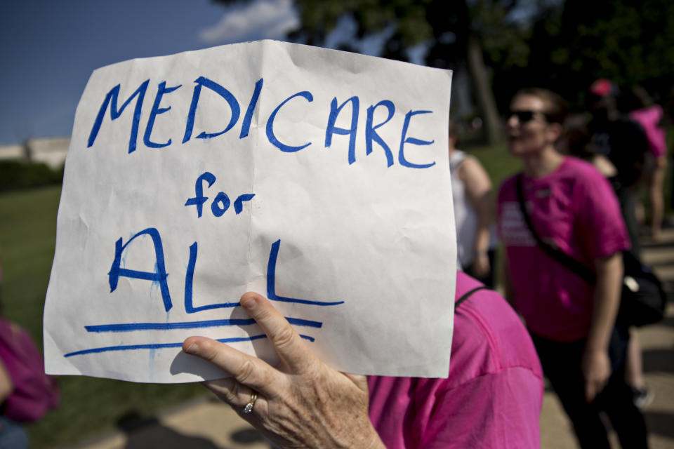 A demonstrator opposed to the Senate Republican health care plan holds a sign while marching near the Capitol on June 28, 2017. (Photo: Andrew Harrer/Bloomberg via Getty Images)