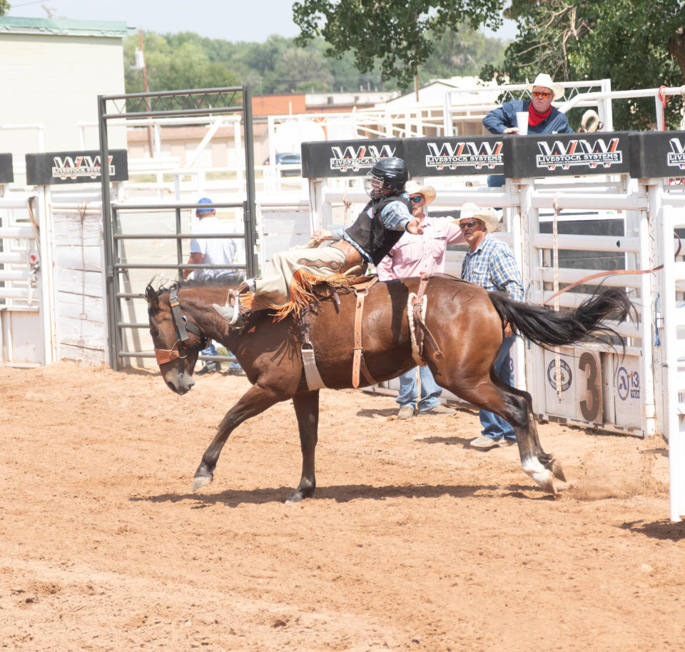 A rider keeps himself in the saddle at the Cal Farley Boys Ranch rodeo dress rehearsal Sunday, Aug. 27 at Boys Ranch.