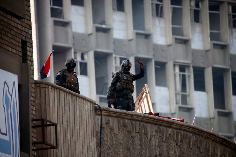 A member of Iraqi Security forces gestures during the ongoing anti-government protests in Baghdad