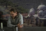 Andriy Kotsar, who was tortured by Russian soldiers, sits at a table after a service at Pishchanskyi church in the recently liberated town of Izium, Ukraine, Monday, Sept. 21, 2022. Russian torture in Izium was arbitrary, widespread and absolutely routine, extending to both civilians and soldiers throughout the city, an AP investigation has found. (AP Photo/Evgeniy Maloletka)