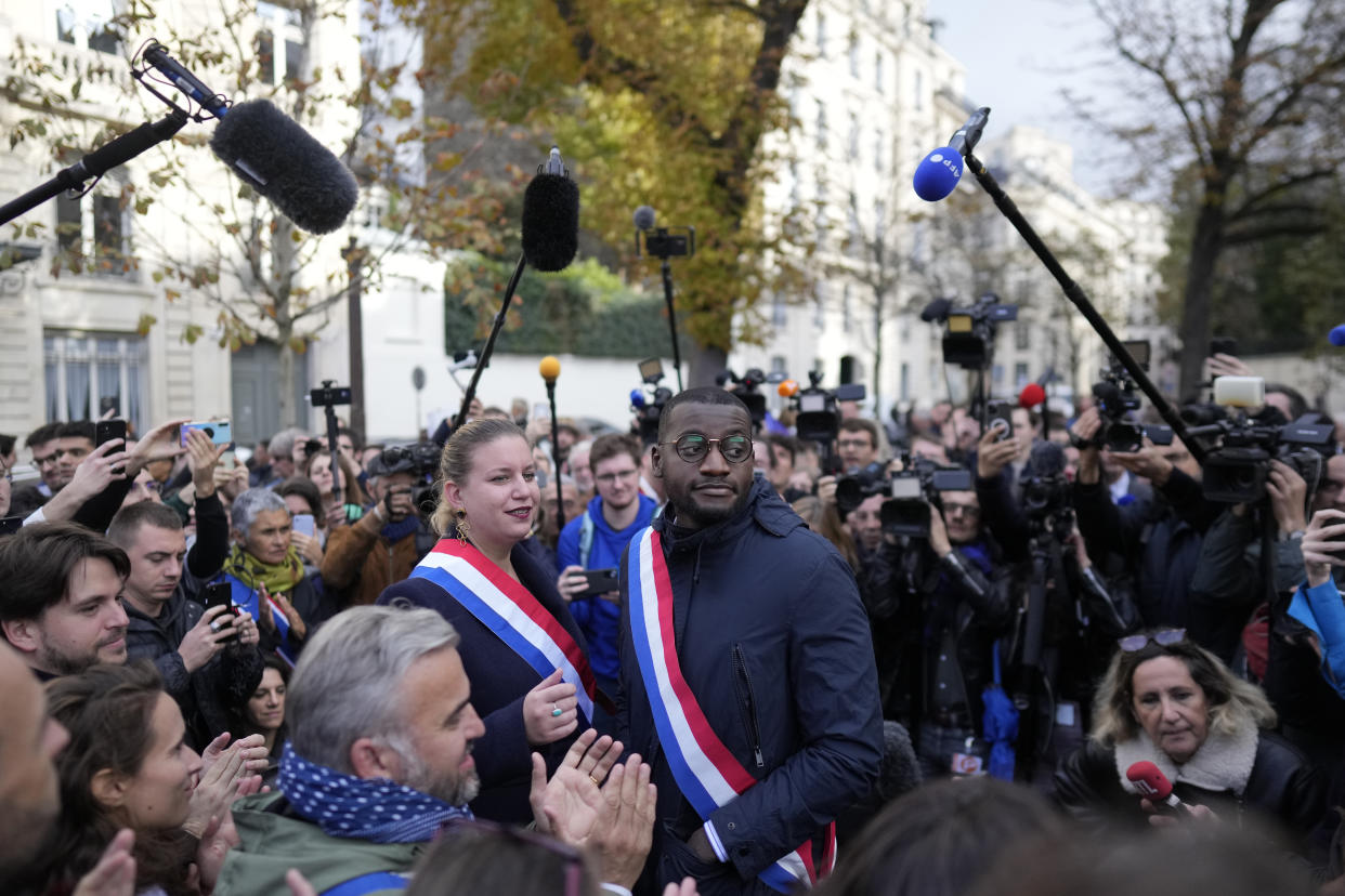 Black lawmaker Carlos Martens Bilongo and lawmaker Mathilde Panot attend a rally Friday, Nov. 4, 2022 outside the National Assembly in Paris. Carlos Martens Bilongo said Friday he was "deeply hurt" after a far-right member of the French parliament made a racist remark during a legislative session, something that has triggered condemnations from across the political spectrum. The comments shocked many, up to France's president himself, and raised new questions about xenophobia on the far right and other parts of French society. (AP Photo/Thibault Camus)