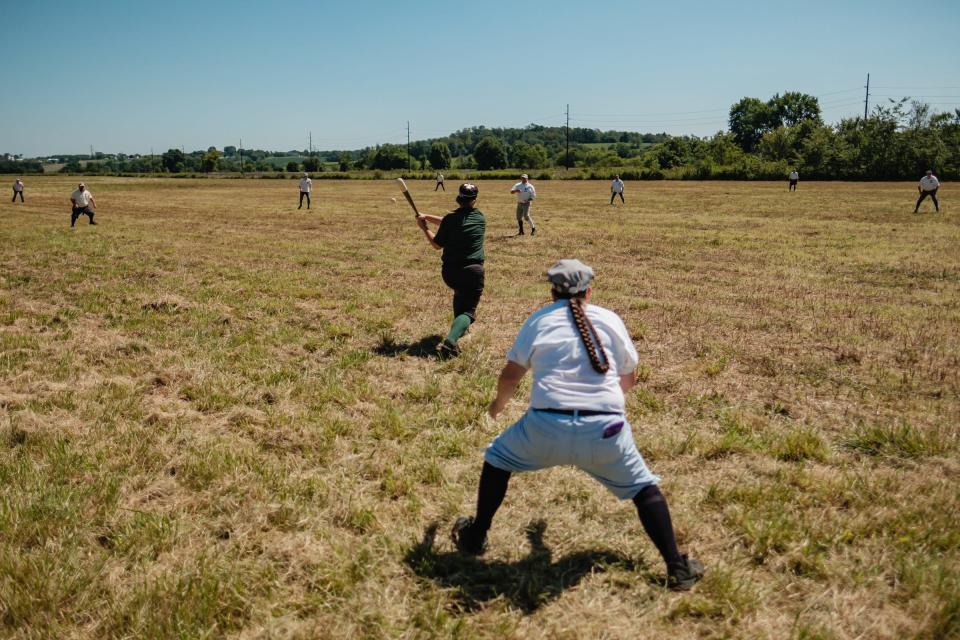 A batter from Whiskey Island Shamrocks hits a single during the ‘Diamonds & Drivers Vintage Baseball Tournament’ game against the Eastwood Iron Horses of Dayton  Saturday, Aug. 27 at the field beside the Age of Steam Roundhouse Museum in Sugarcreek. Games are played using 1860’s rules, uniforms, equipment and etiquette.