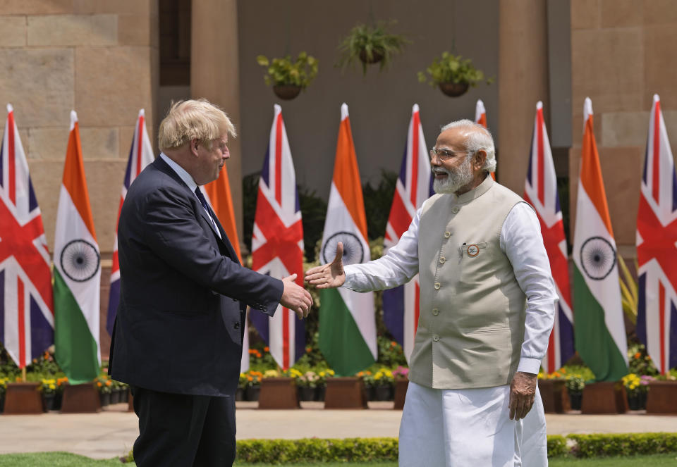 Indian Prime Minister Narendra Modi shakes hand with his British counterpart Boris Johnson before their delegation level talks in New Delhi, Friday, April 22, 2022. Johnson is expected to help move India away from its dependence on Russia by expanding economic and defense ties when he meets with his Indian counterpart Friday, officials said. (AP Photo/Manish Swarup)