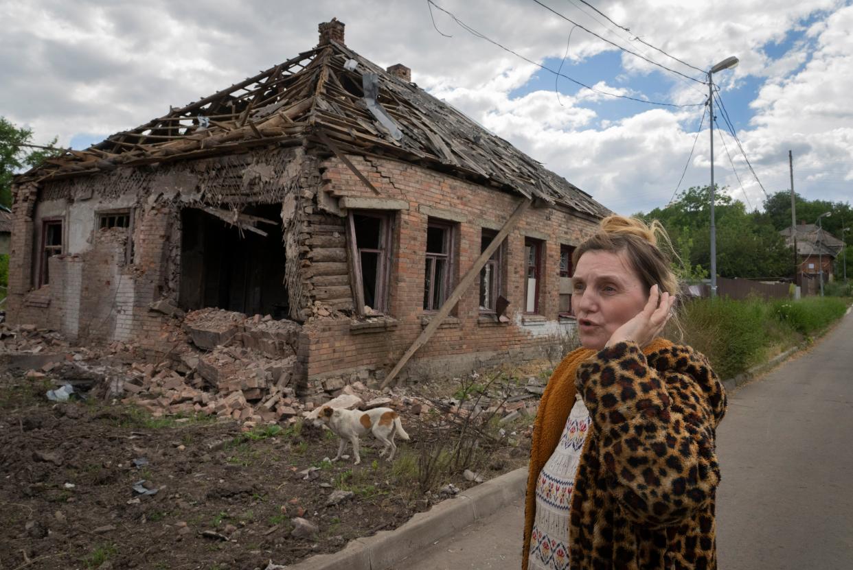 Local resident Tetyana stands in front of her damaged house following Russian shelling in Bakhmut, Donetsk region, Ukraine, Friday, June 24, 2022. 