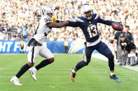 <p>Keenan Allen #13 of the Los Angeles Chargers fends off T.J. Carrie #38 of the Oakland Raiders as Allen makes the catch during the third quarter of the game at StubHub Center on December 31, 2017 in Carson, California. (Photo by Harry How/Getty Images) </p>