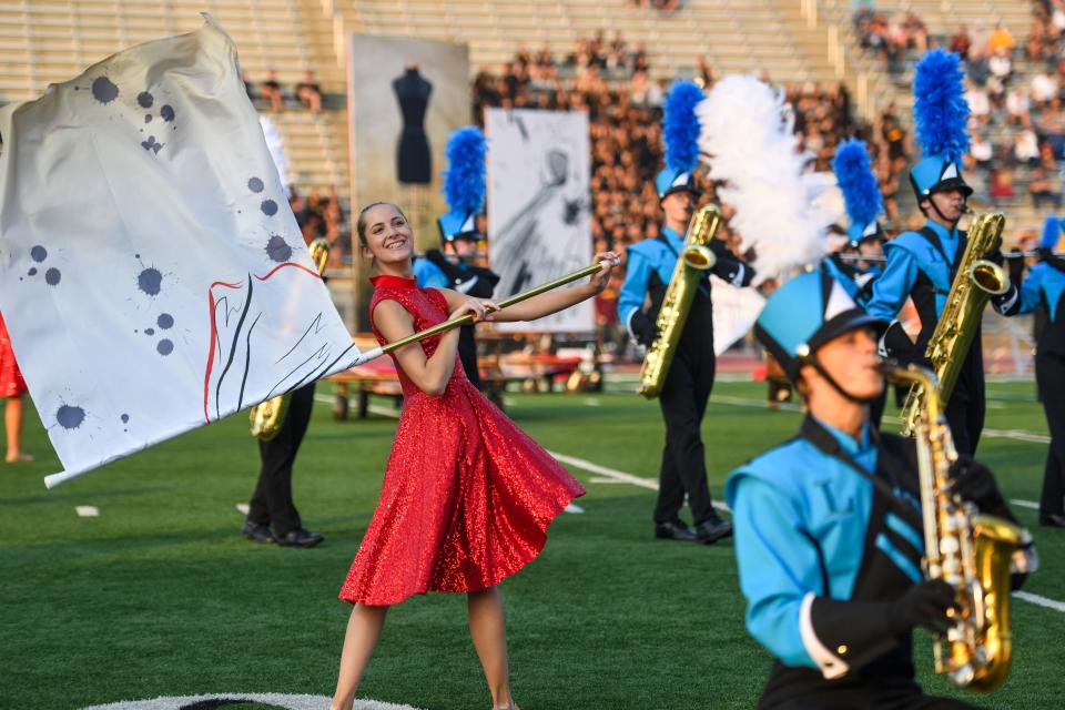 Lincoln color guard performs with flags during their halftime performance on Friday, Sept. 15, 2023 at Howard Wood Field in Sioux Falls, South Dakota.