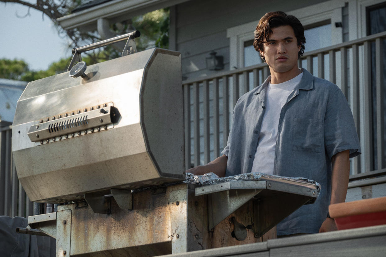 Joe stands on a deck grilling in a blue shirt  (François Duhamel / Courtesy of Netflix )