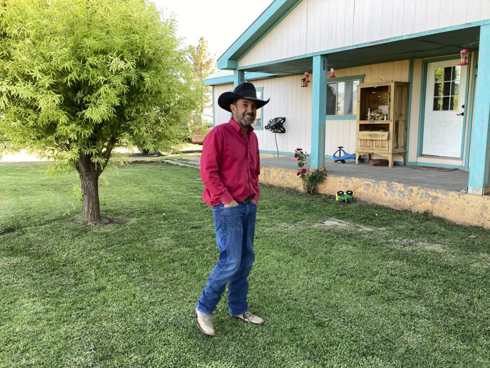 Otero County Commissioner Couy Griffin, the founder of Cowboys for Trump, strides through his front yard in Tularosa, N.M., on Wednesday, May 12, 2021. Griffin is reviled and revered in politically conservative Otero County as he confronts criminal charges for joining protests on the steps of the U.S. Capitol on Jan. 6. He is fighting for his political future amid a recall initiative and state probes into his finances. (AP Photo/Morgan Lee)