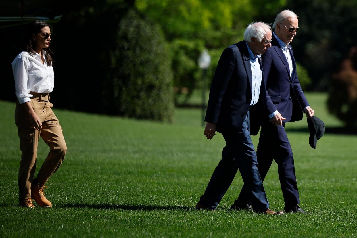 WASHINGTON, DC - APRIL 22: U.S. President Joe Biden (R) and Sen. Bernie Sanders (I-VT) are joined by Rep. Alexandria Ocasio-Cortez (D-NY) as they walk across the South Lawn after returning to the White House on board the Marine One presidential helicopter on April 22, 2024 in Washington, DC. Biden, Sanders, Ocasio-Cortez and Sen. Ed Markey (D-MA) returned to the White House following an Earth Day event in Virginia. (Photo by Chip Somodevilla/Getty Images)