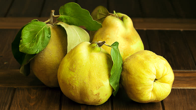 quinces on wooden table