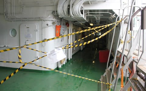 Hazard tape was stretched across several areas with signs instructing crew to access them through different corridors - Credit: Alec Luhn/For The Telegraph