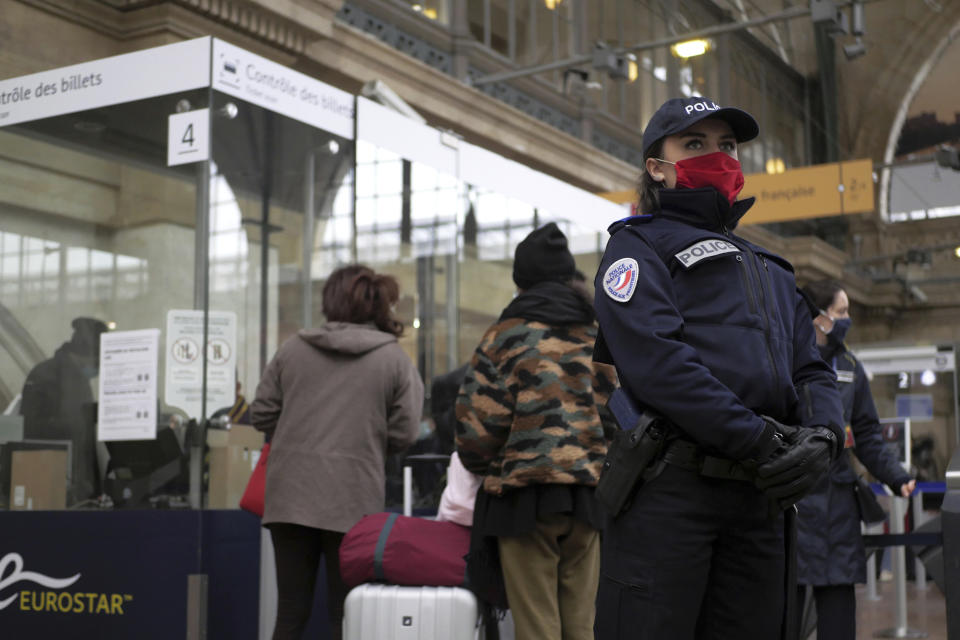 A police officer stands on the boarding platform for Britain after Brexit, Friday Jan.1, 2021 at the Gare du Nord railway station, in Paris. Britain left the European bloc's vast single market for people, goods and services at 11 p.m. London time, midnight in Brussels, completing the biggest single economic change the country has experienced since World War II. (AP Photo/Thibault Camus)