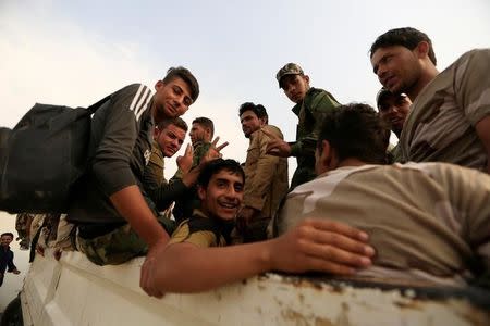 Fighters who were displaced by Islamic State gather at Debaga camp on the outskirts of Erbil, Iraq, before heading to the front line for the Mosul offensive against the group, October 24, 2016. REUTERS/Zohra Bensemra