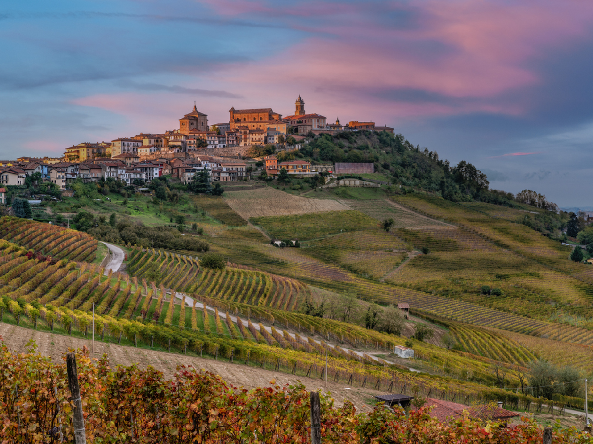 Terracotta hilltop towns overlook sprawling vineyards in the Piedmont region of Italy  (Getty/iStock)