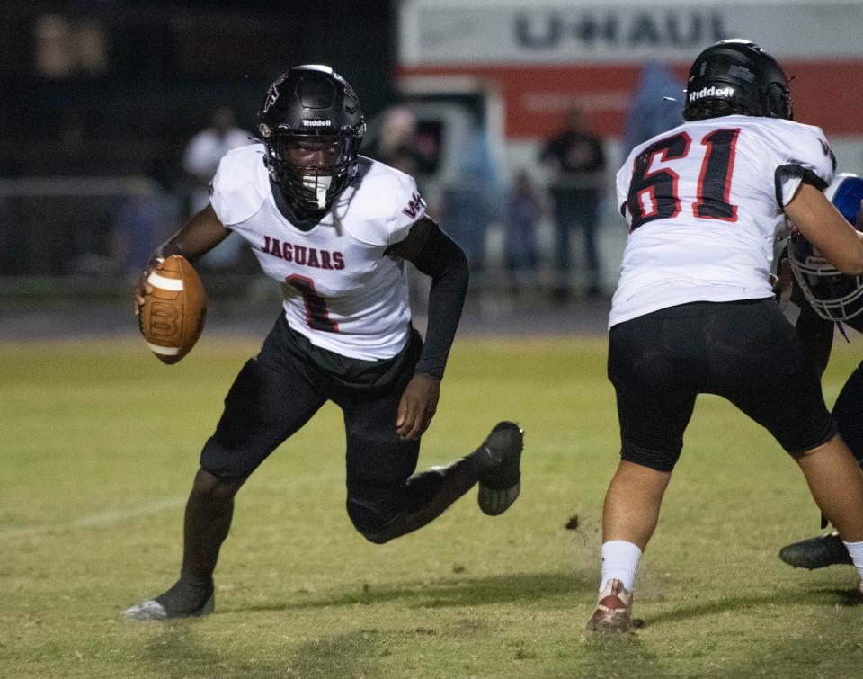 Quarterback Markell Redding (1) keeps the ball during the West Florida vs Washington football game at Booker T. Washington High School in Pensacola on Friday, Sept. 2, 2022.