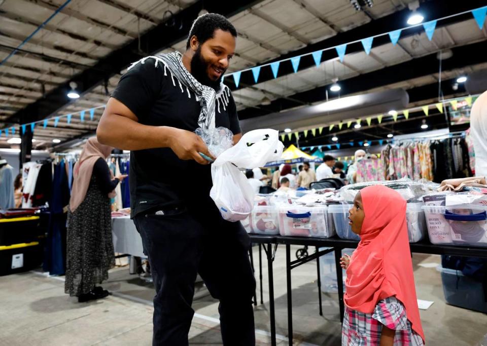 Myles Keeys-Turner talks with his daughter Sage, 3, while they attend the Eid Festival at the Jim Graham Building in Raleigh, N.C. Saturday, June 22, 2024. Eleven Triangle mosques and Islamic organizations joined forces to hold what was billed as North Carolina’s largest Eid festival.