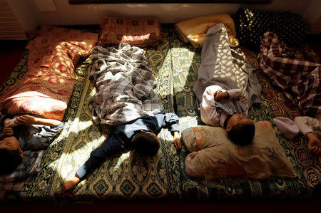 Younger students take an afternoon nap at the Al-Nadwa Madrassa in Murree, Pakistan, October 24, 2017. REUTERS/Caren Firouz