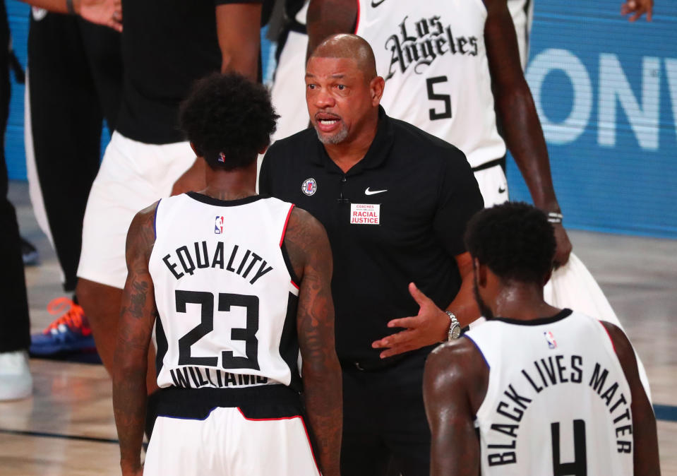 Doc Rivers talks with one of his players.