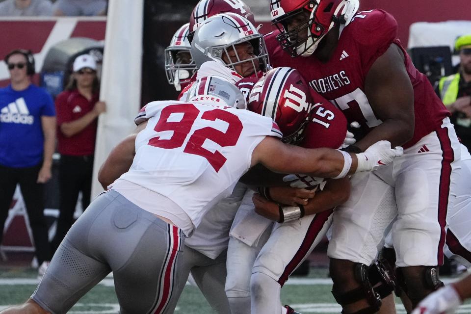 Ohio State's Caden Curry (92) and Hero Kanu tackle Indiana quarterback Brendan Sorsby on Sept. 2.