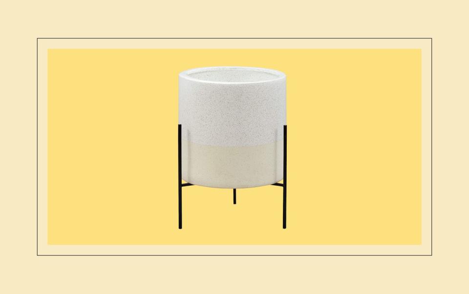 White planter on yellow background.