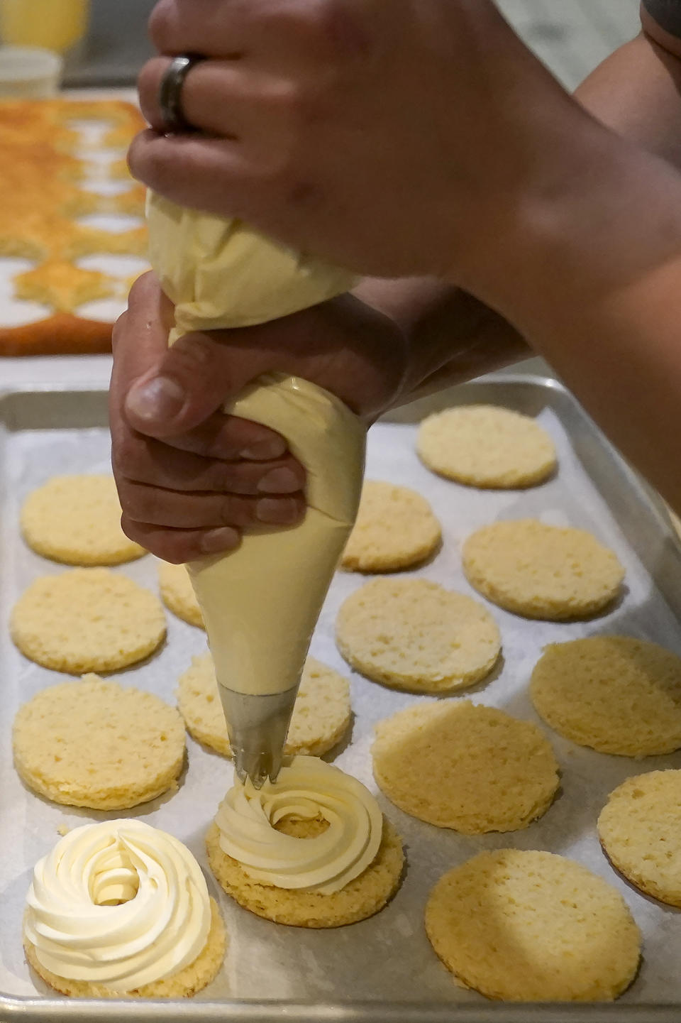 Pastry chef Vince Bugtong prepares Yema cakes, a salted egg cake with almond yogurt and salted egg yolk custard, at Abaca restaurant in San Francisco, Monday, May 15, 2023. Three Filipino restaurants in three different areas of the U.S. will be representing at this year's James Beard Awards, the culinary world's equivalent of the Oscars. The awards ceremony is next week in Chicago. (AP Photo/Jeff Chiu)