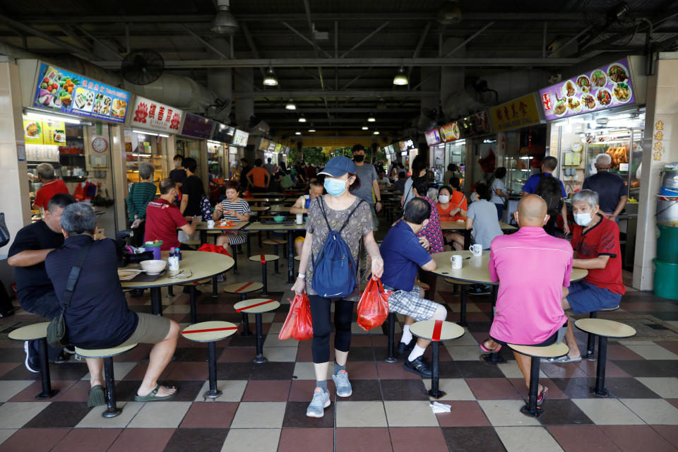 People dine at a hawker center in Singapore as the city state reopens the economy amid the coronavirus disease (COVID-19) outbreak, June 19, 2020.  REUTERS/Edgar Su