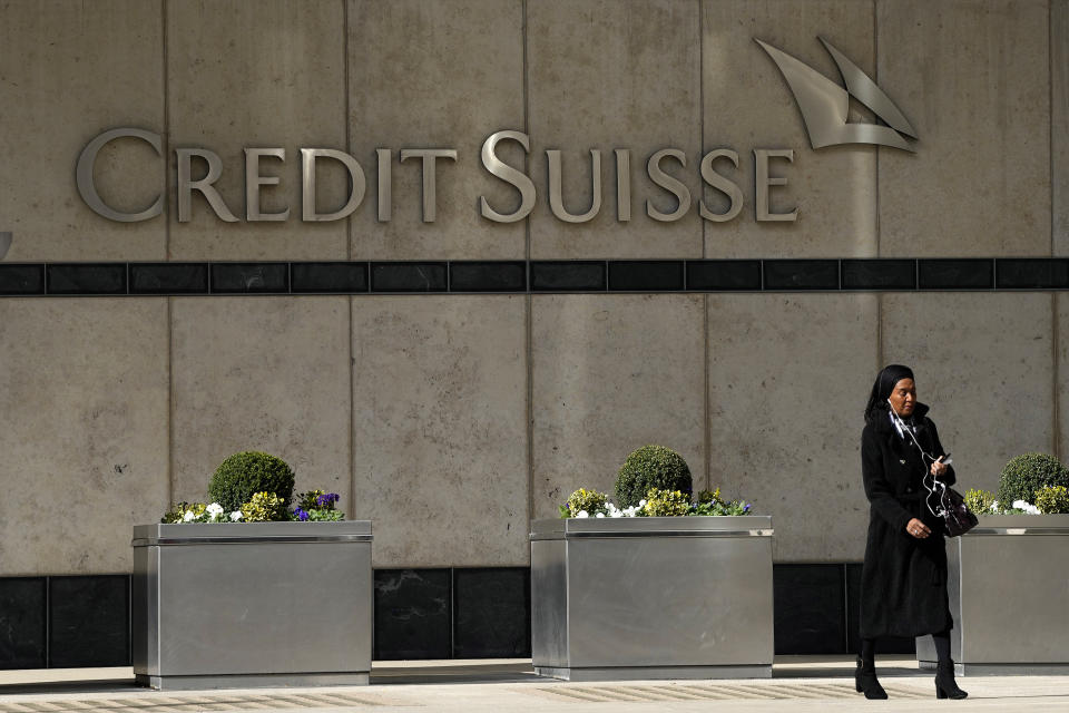A woman walks past the Credit Suisse bank headquarters in London, Thursday, March 16, 2023. Credit Suisse's shares soared 30% on Thursday after it announced it will move to shore up its finances by borrowing up to nearly $54 billion from the Swiss central bank, bolstering confidence as fears about the banking system moved from the U.S. to Europe.(AP Photo/Frank Augstein)