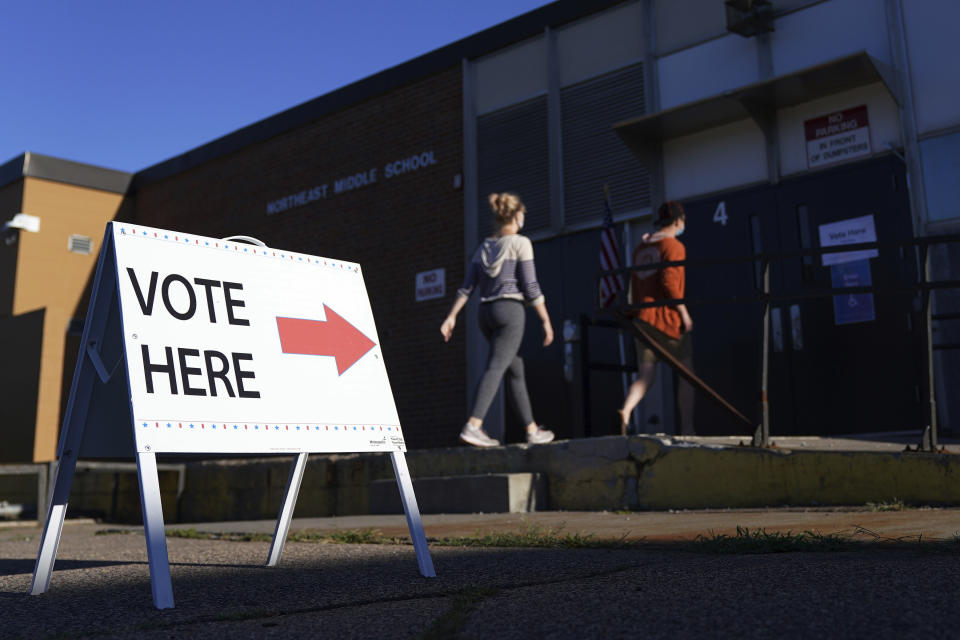 Voters arrive to cast their ballots at Northeast Middle School in Minneapolis, Minnesota, during the first election in Minnesota since the full outbreak of the COVID-19 pandemic, Tuesday, Aug. 11, 2020. (Anthony Souffle/Star Tribune via AP)