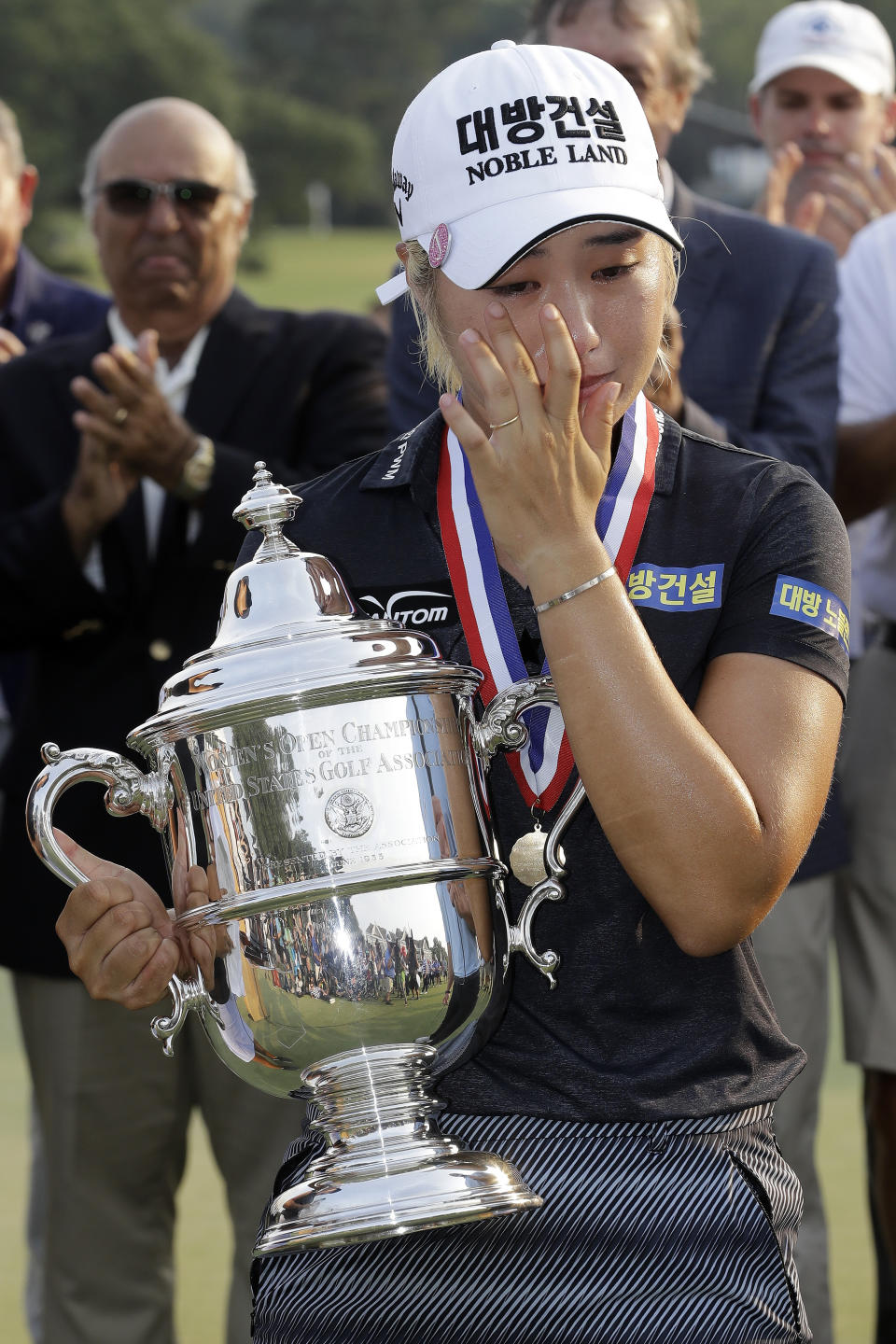 Jeongeun Lee6 of South Korea, is congratulated and holds the championship trophy after winning the final round of the U.S. Women's Open golf tournament, Sunday, June 2, 2019, in Charleston, S.C. (AP Photo/Steve Helber)