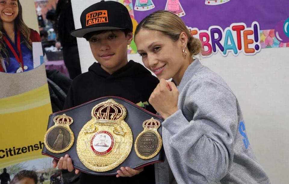Seniesa ‘Super Bad’ Estrada poses for a photo with a boy during a visit to the Boys & Girls Club in central Fresno on March 22. She will face Germany’s Tina Rupprecht on March 25 at the Save Mart Center for the WBA and WBC minimumweight world titles.