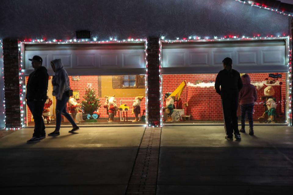 People check out a Christmas scene inside the garage of a house on Minerva Road in Cathedral City, December 15, 2021.