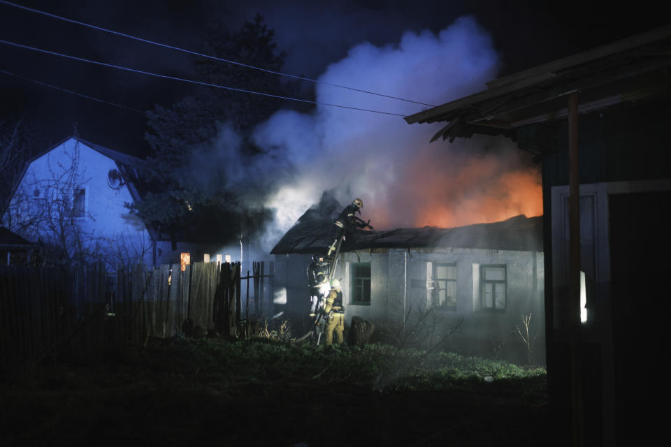 Rescue workers extinguish the fire of a house which was destroyed after a Russian drone strike on residential neighborhood in Kharkiv, Ukraine, on Thursday, April 4, 2024. (AP Photo/George Ivanchenko)