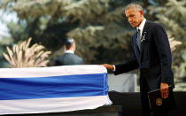 <p>President Barack Obama touches the flag-draped coffin of former Israeli President Shimon Peres, after eulogising him at his funeral ceremony in Mount Herzl cemetery in Jerusalem September 30, 2016. (Kevin Lamarque/Reuters) </p>