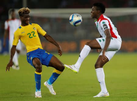 Gabon's Didier Ibrahim Ndong (L) challenges Burkina Faso's Alain Sibiri Traore during their Group A soccer match at the 2015 African Cup of Nations in Bata January 17, 2015. REUTERS/Mike Hutchings